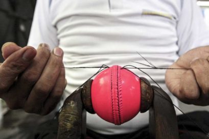A worker at SG’s factory in Meerut stitches the leather seam of a pink ball