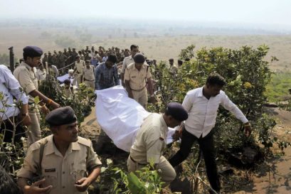 Policemen carry the bodies of SIMI activists killed in an encounter after they escaped from jail in Bhopal