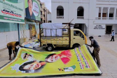 Workers remove posters with Sasikala’s image at the AIADMK office in Chennai