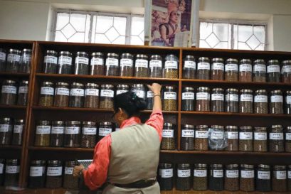 Yeshi Choedron selects Sowa Rigpa pills for a prescription at a Men-Tse-Khang clinic in Dharamshala
