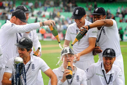 Alastair Cook (left) with the trophy after England’s 3-1 win in 2014
